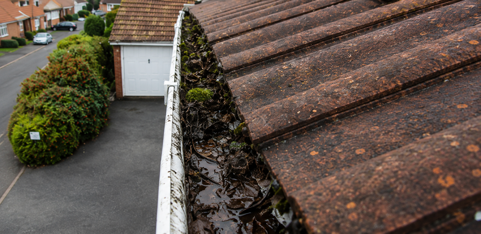 Birmingham gutter before professional cleaning showing compacted debris that silently damages fascia boards and soffits