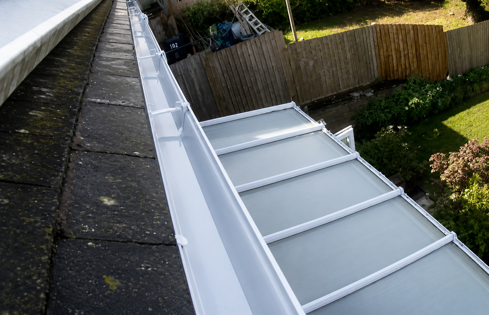 After professional gutter cleaning showing clear channel floor, verified joints, and unobstructed drainage