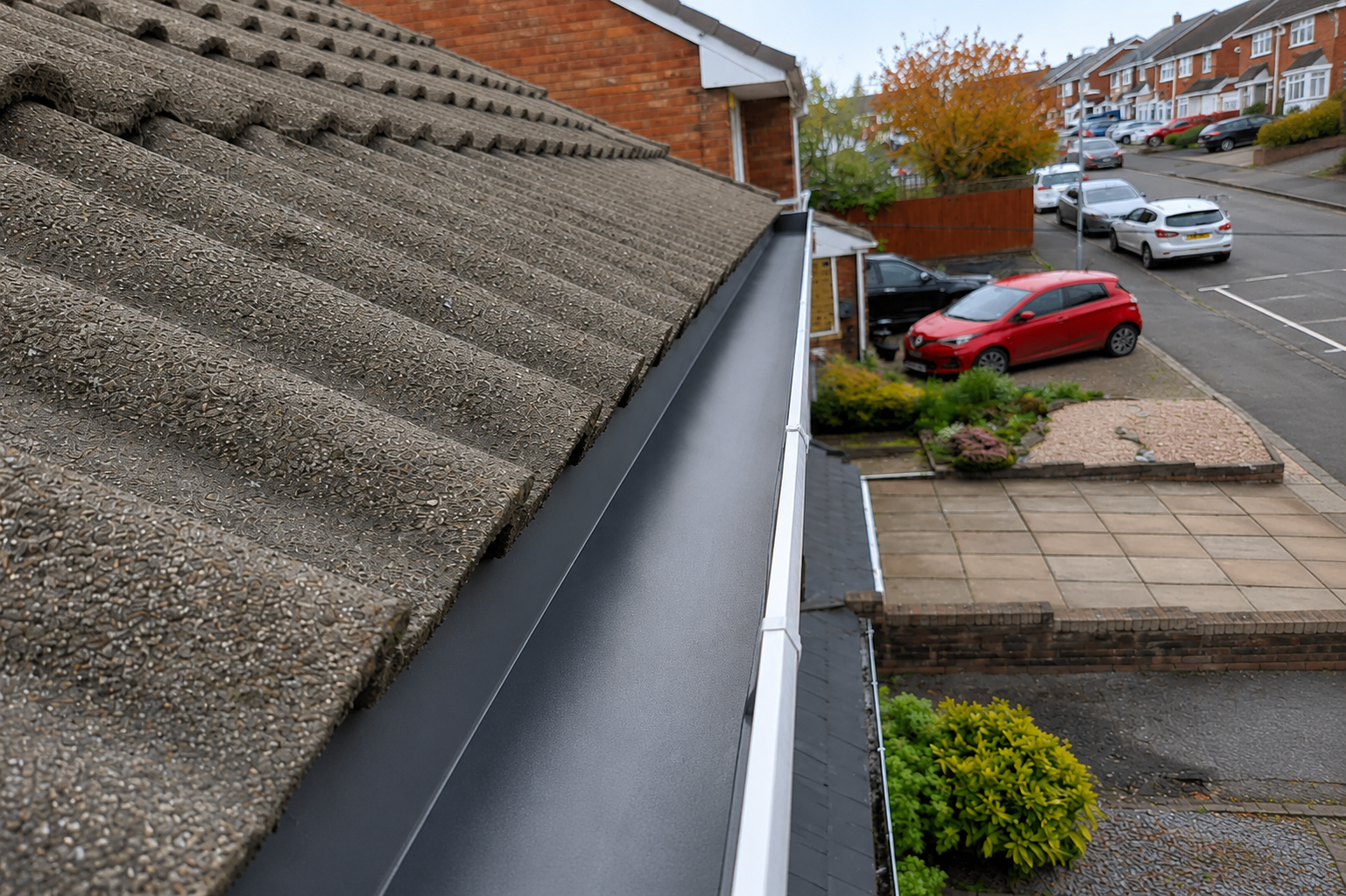 After professional gutter cleaning showing clean channel floor, cleared outlets, and verified bracket integrity
