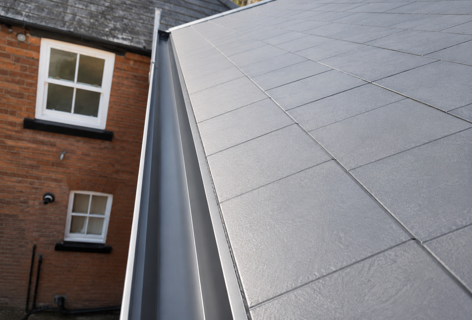 After gutter cleaning showing fully cleared gutter channel with free-flowing rainwater drainage