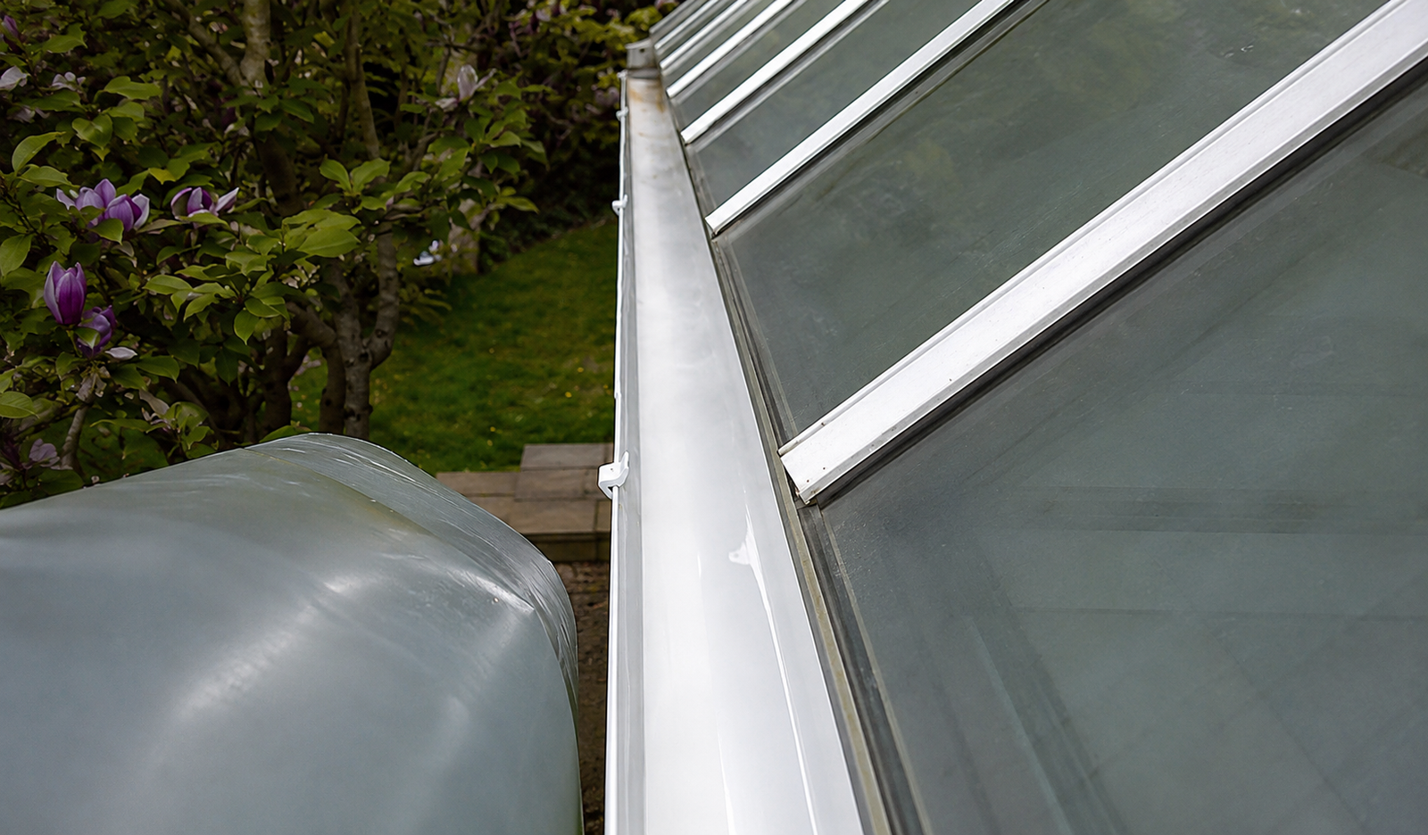 After gutter cleaning — same gutters fully cleared to the channel with downpipes running freely