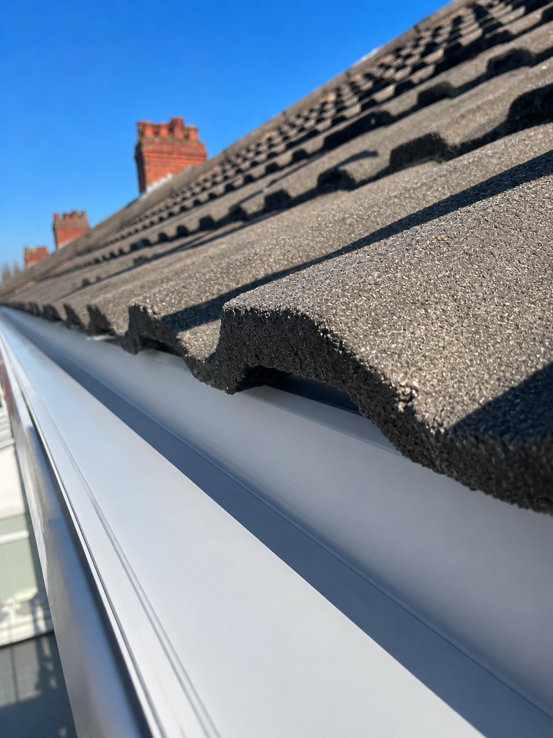 After gutter cleaning in Bartley Green Birmingham B32 — gutter fully cleared to the plastic channel, downpipe flowing freely, WOW Gutters 2026